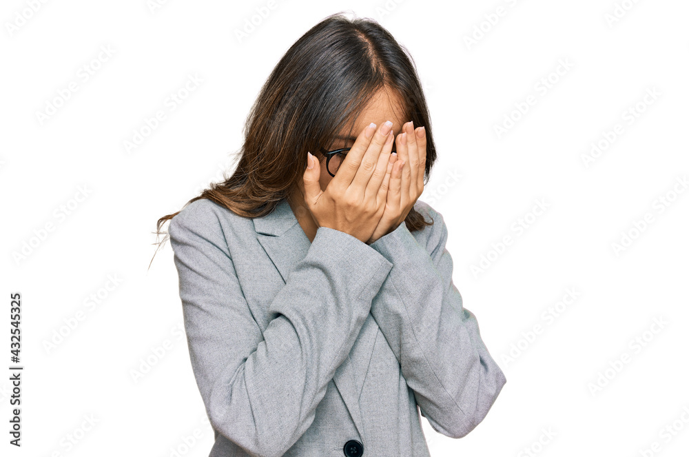 Young brunette woman wearing business clothes with sad expression covering face with hands while crying. depression concept. Young brunette woman wearing business clothes with sad expression covering face with hands while crying. depression concept.