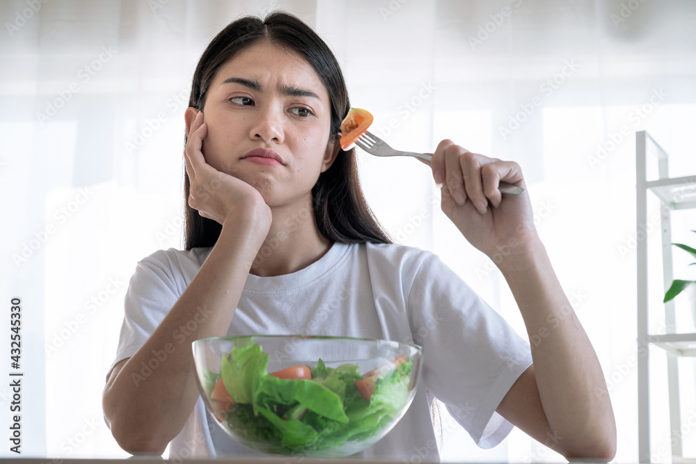 Asian woman feel anorexia, The girl does not like to eat vegetables, Healthy food. Asian woman feel anorexia, The girl does not like to eat vegetables, Healthy food.