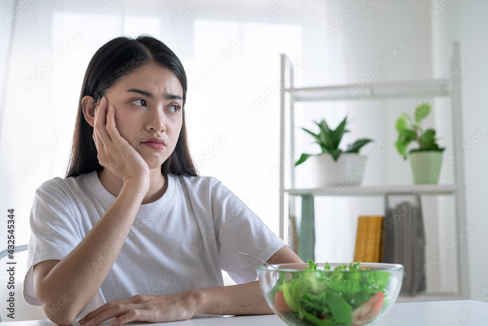 Asian woman feel anorexia, The girl does not like to eat vegetables, Healthy food. Asian woman feel anorexia, The girl does not like to eat vegetables, Healthy food.