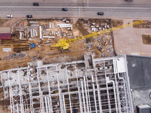 Aerial flight over construction site and construction crane. Aerial photography