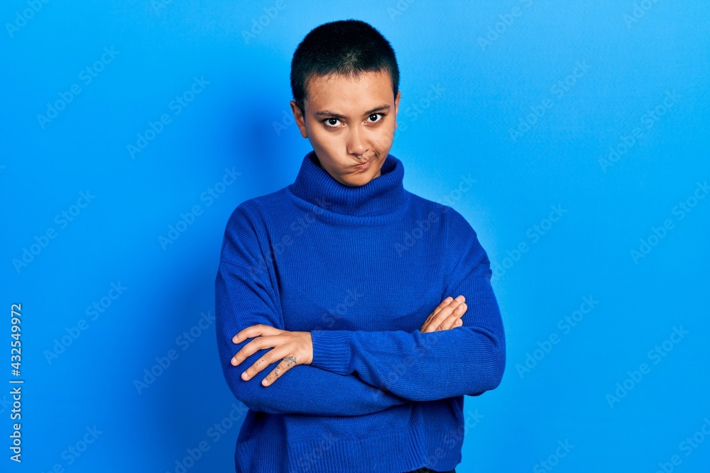 Beautiful hispanic woman with short hair wearing turtleneck sweater skeptic and nervous, disapproving expression on face with crossed arms. negative person. Beautiful hispanic woman with short hair wearing turtleneck sweater skeptic and nervous, disapproving expression on face with crossed arms. negative person.