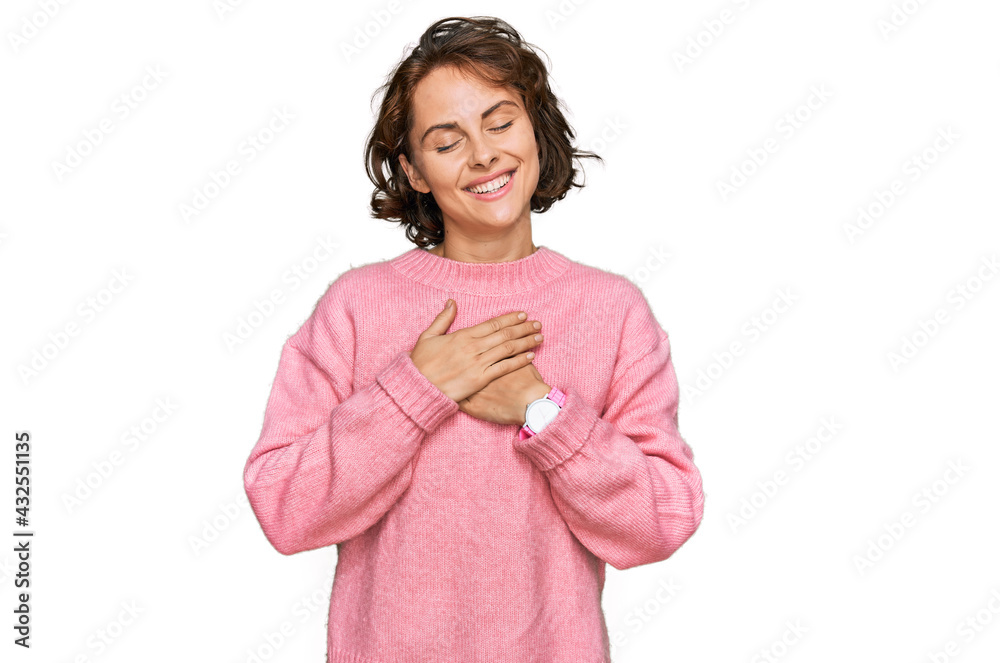 Young hispanic woman wearing casual clothes smiling with hands on chest with closed eyes and grateful gesture on face. health concept. Young hispanic woman wearing casual clothes smiling with hands on chest with closed eyes and grateful gesture on face. health concept.