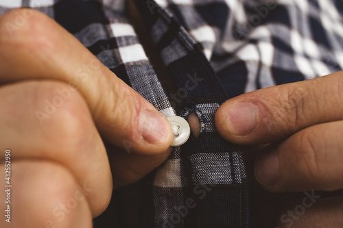 The guy's fingers are buttoned up in close-up