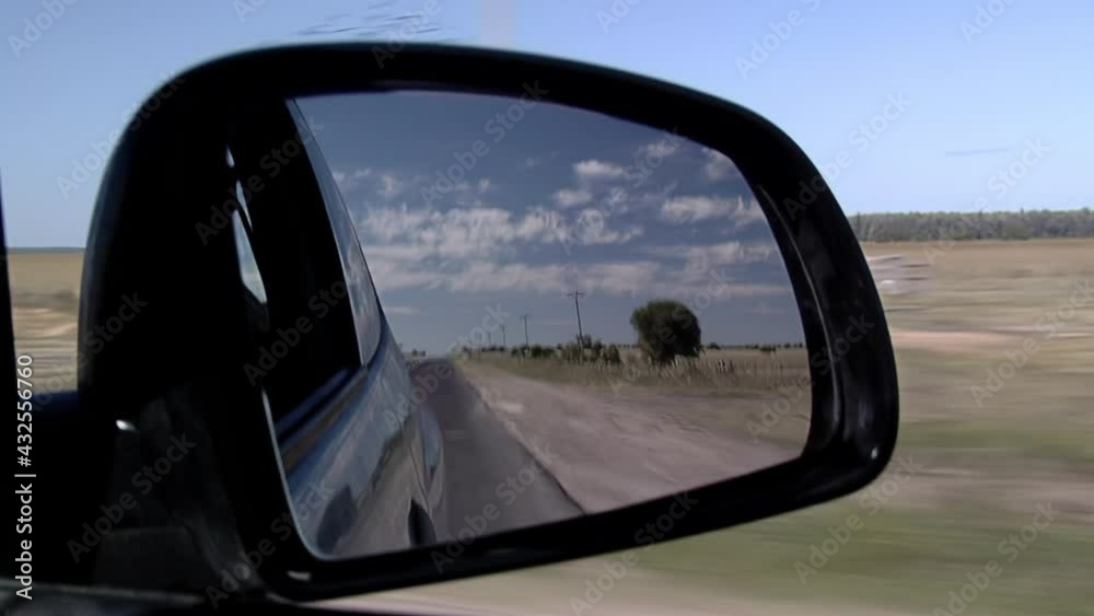 Side Mirror of Car (or Wing mirror) on Road. Travel Concept, Suggests Moving On from the Past. Close Up. Side Mirror of Car (or Wing mirror) on Road. Travel Concept, Suggests Moving On from the Past. Close Up.