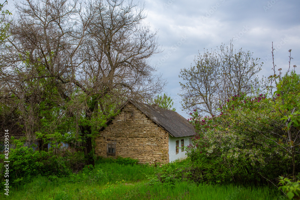 landscape with old, forgotten house, abandoned somewhere in the villages of Moldova. Abandoned house in Republic of Moldova. Depopulation concept.