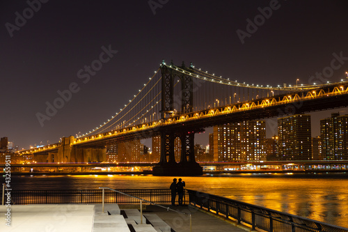 Manhattan Bridge at night, with a viewing platform on Brooklyn side, New York, USA.