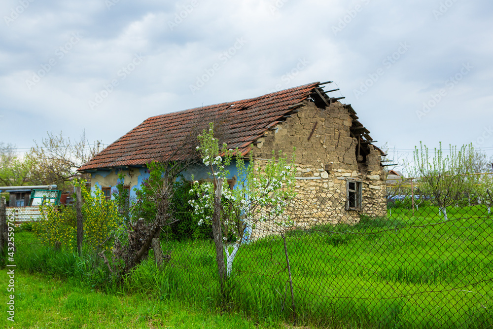 Obraz premium landscape with old, forgotten house, abandoned somewhere in the villages of Moldova. Abandoned house in Republic of Moldova. Depopulation concept.