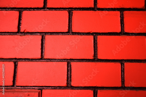 New red colour wall of bricks and cement of home. good background texture