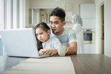 father or husband working from home while child is sitting on his lap