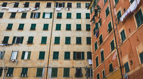 Facade in a backyard in Italy with cloths hanging outside for drying