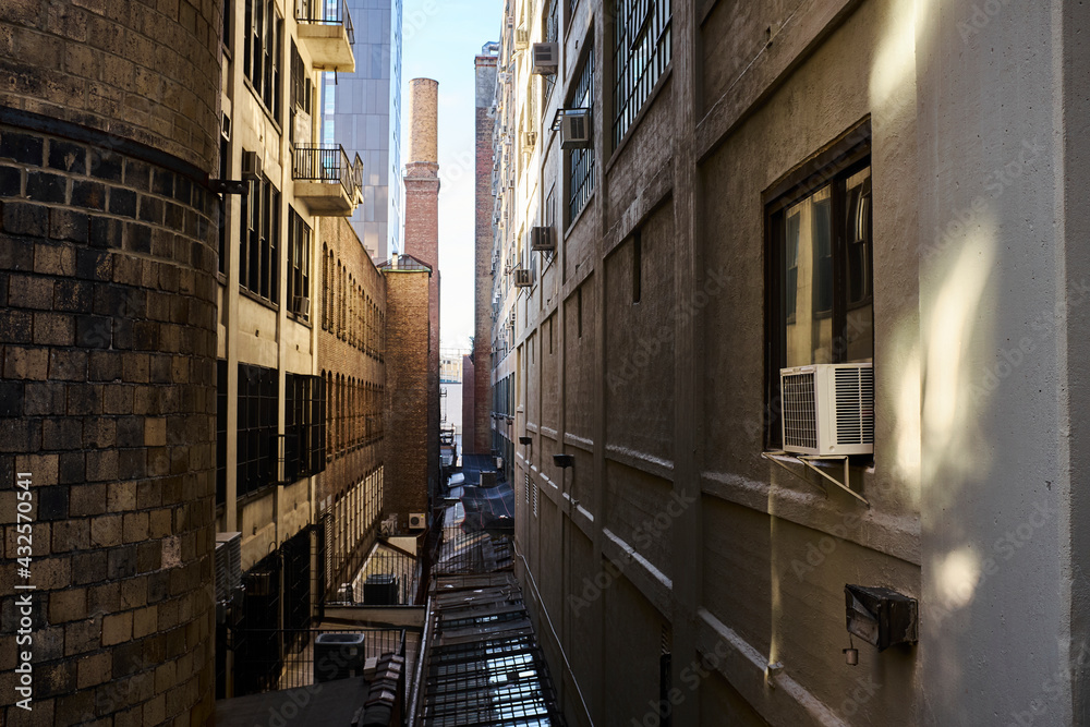 Industrial back alley with brick chimney in background Industrial back alley with brick chimney in background