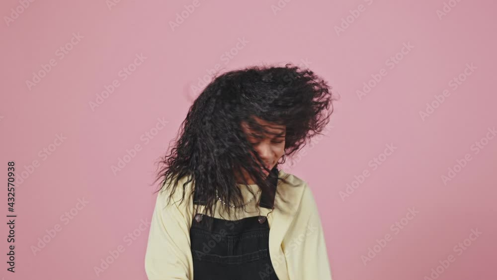 Awesome young curly african american lady dancing, enjoying great nightclub music, violet background, slow motion Awesome young curly african american lady dancing, enjoying great nightclub music, violet background, slow motion