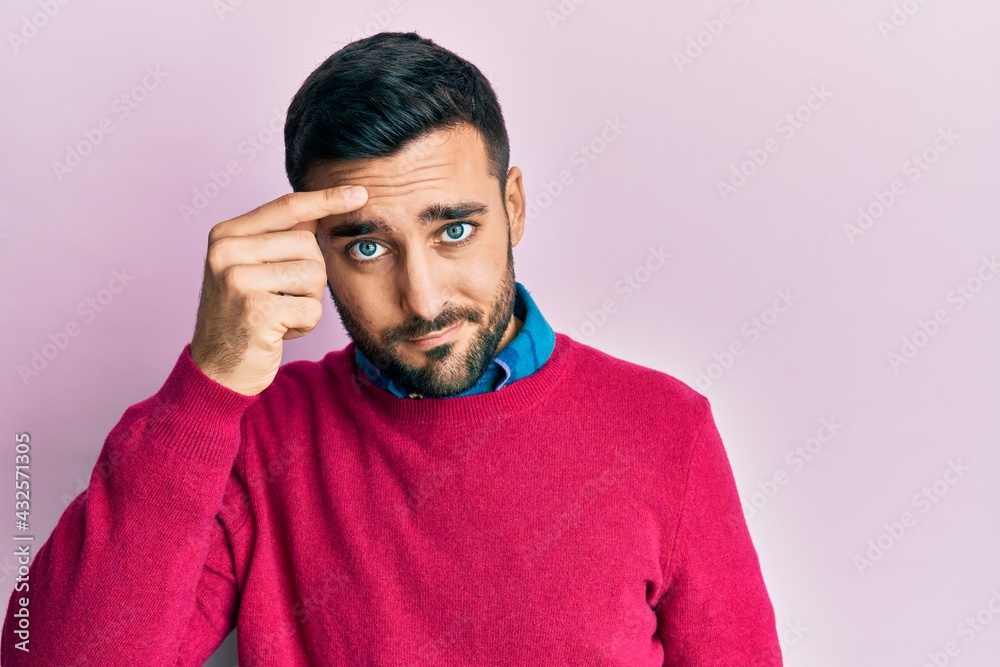 Young hispanic man wearing casual clothes pointing unhappy to pimple on forehead, ugly infection of blackhead. acne and skin problem Young hispanic man wearing casual clothes pointing unhappy to pimple on forehead, ugly infection of blackhead. acne and skin problem