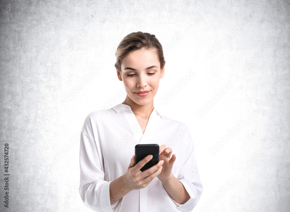 Businesswoman smiling with phone in hands, mockup empty wall Businesswoman smiling with phone in hands, mockup empty wall