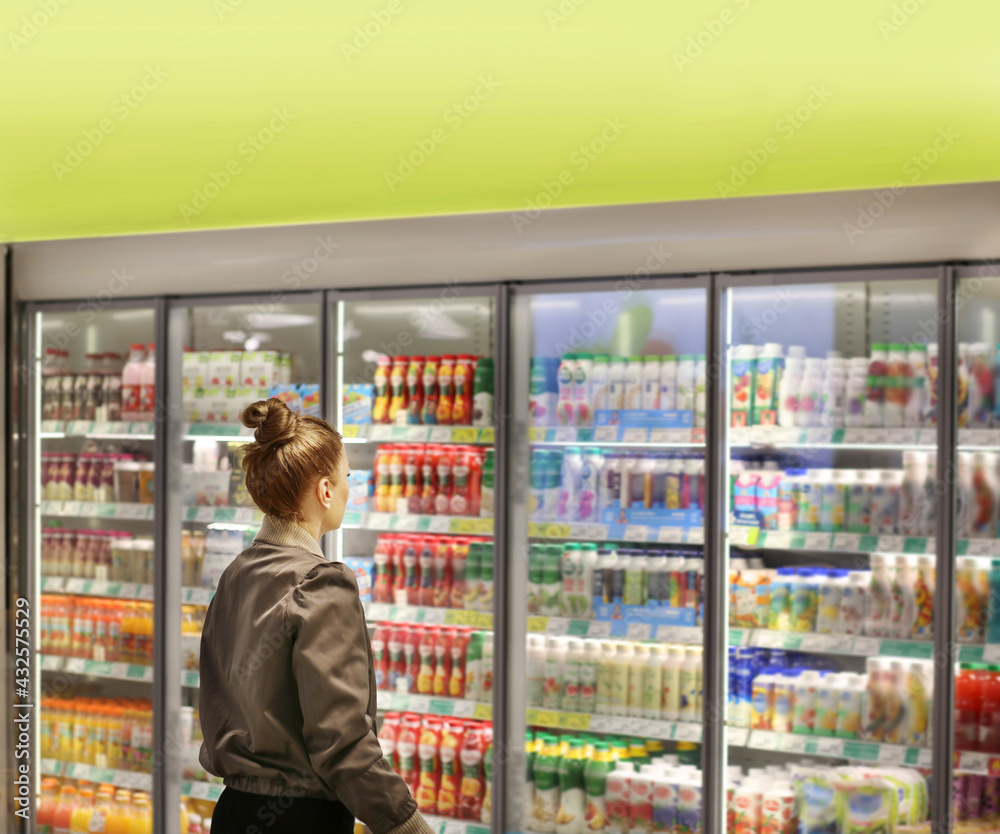 Woman choosing a dairy products at supermarket