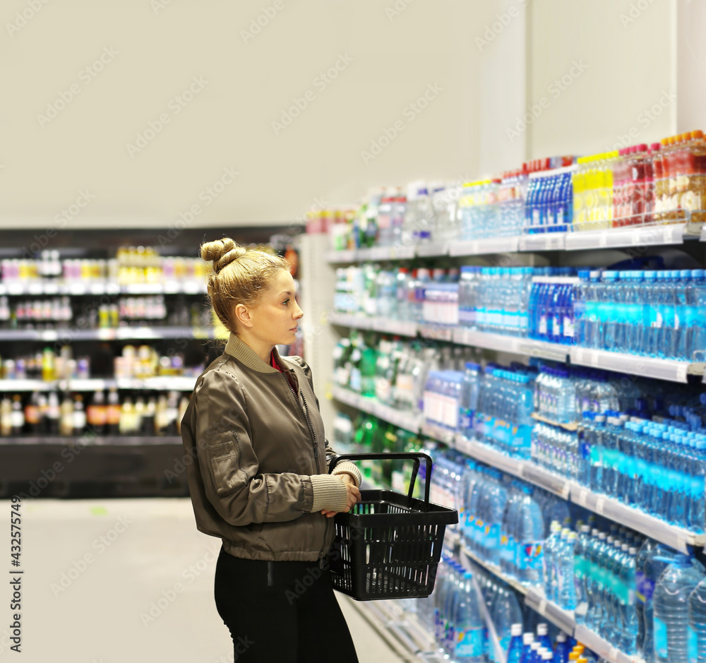Woman  Buying a bottle of water in a supermarket