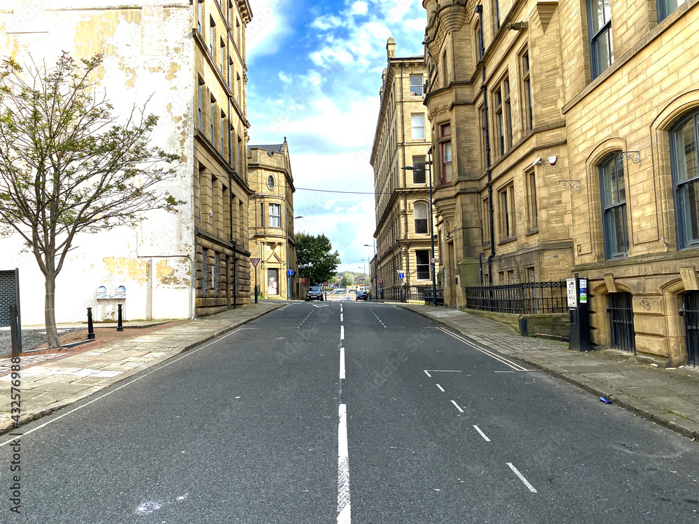 View along, Chapel Street, with Victorian stone buildings, built for the textile trade in, Little Germany, Bradford, UK