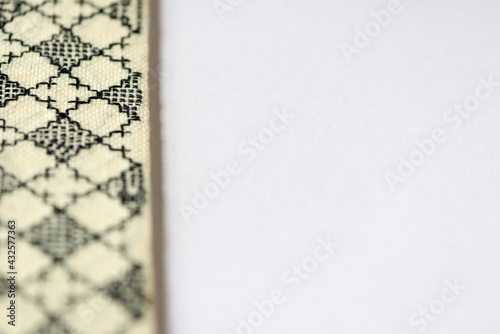 simple blackwork embroidery on pale yellow even-weave cloth on a white background - book-covers photo