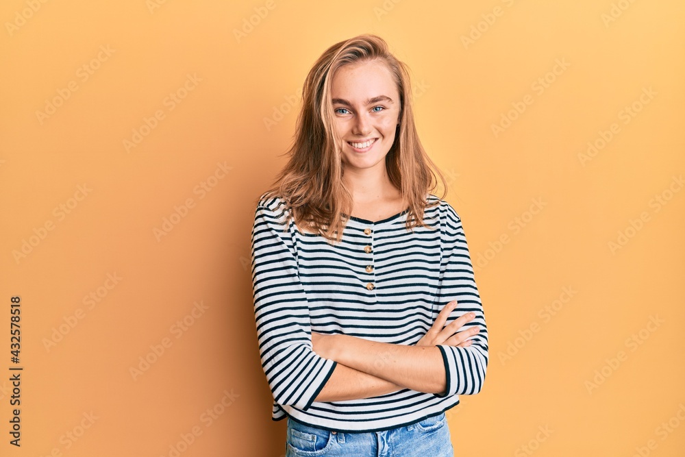 Beautiful blonde woman wearing casual clothes happy face smiling with crossed arms looking at the camera. positive person. Beautiful blonde woman wearing casual clothes happy face smiling with crossed arms looking at the camera. positive person.