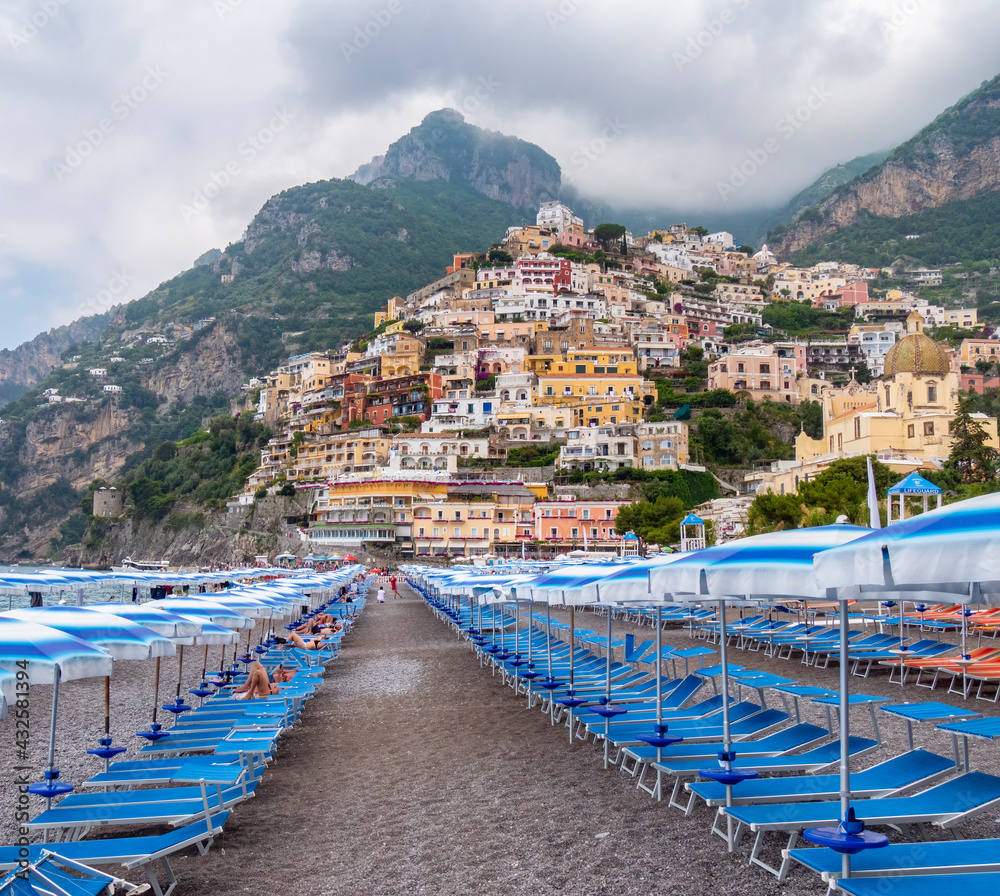 low angle shot of chairs and umbrellas on positano beach of the amalfi coast