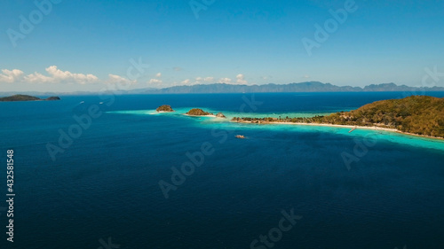 Aerial view: Lagoon with blue, azure water in the middle of small islands and rocks, Palawan. Beach, tropical island, sea bay and lagoon, mountains with forest, Coron. Busuanga. Seascape, tropical