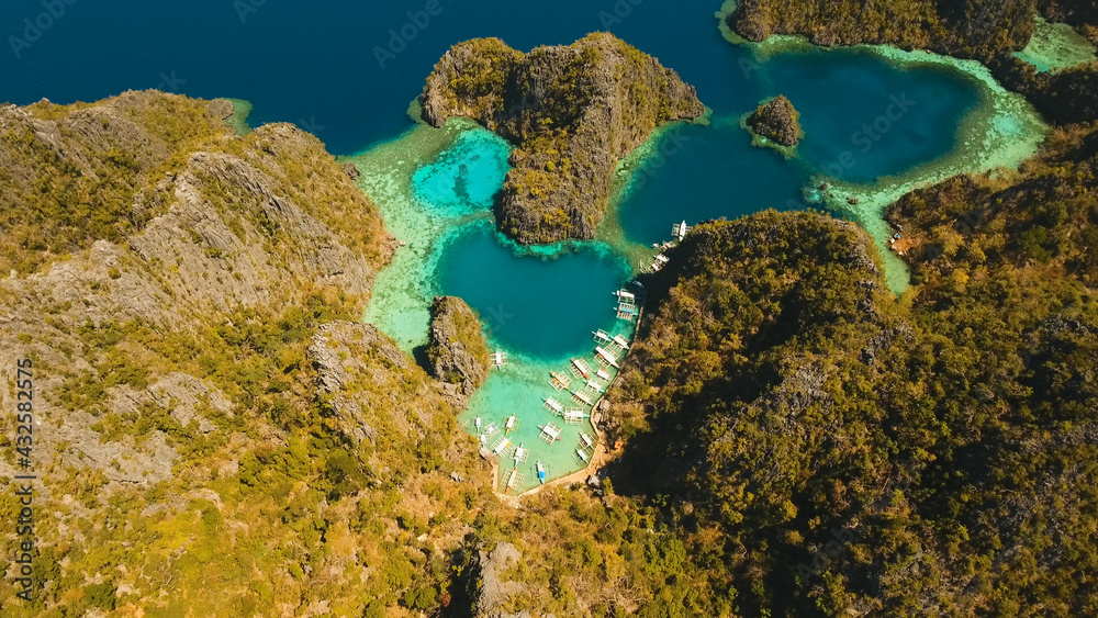 Tropical lagoon with azure water, beach Kayangan Lake, Philippines. Aerial view Coron island, with cove, bay at Kayangan lake. Lagoon with sailing boats. Aerial video. Philippines. Travel concept