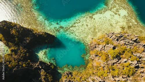 Aerial view: Twin Lagoon with blue, azure water in the middle of small islands and rocks. Beach, tropical island, sea bay and lagoon, mountains with forest, Palawan, Coron. Busuanga. Seascape © Alex Traveler