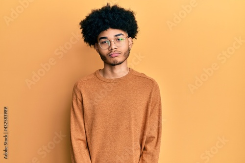 Young african american man with afro hair wearing casual winter sweater depressed and worry for distress, crying angry and afraid. sad expression. © Krakenimages.com
