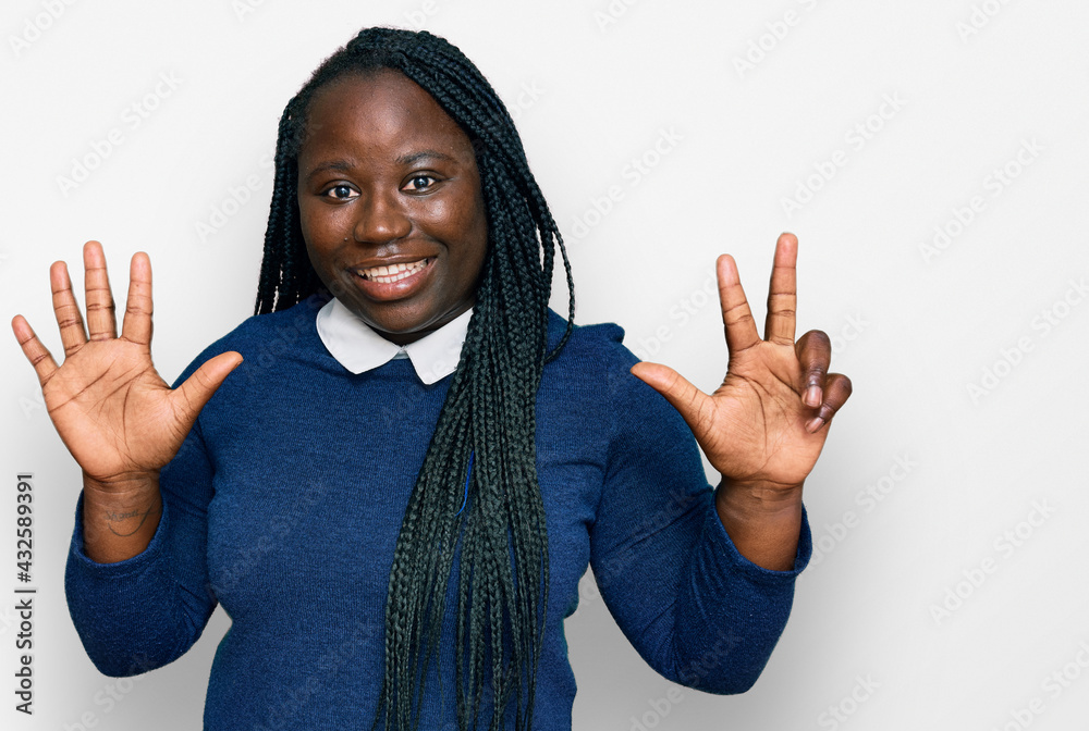 Young black woman with braids wearing casual clothes showing and pointing up with fingers number eight while smiling confident and happy. Young black woman with braids wearing casual clothes showing and pointing up with fingers number eight while smiling confident and happy.