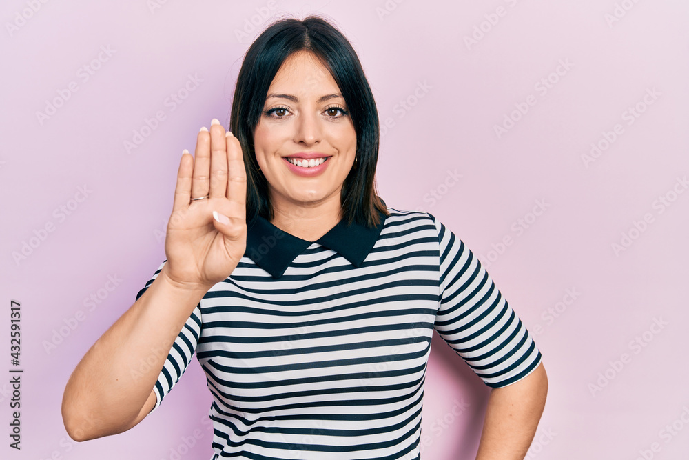 Young hispanic woman wearing casual clothes showing and pointing up with fingers number four while smiling confident and happy. Young hispanic woman wearing casual clothes showing and pointing up with fingers number four while smiling confident and happy.