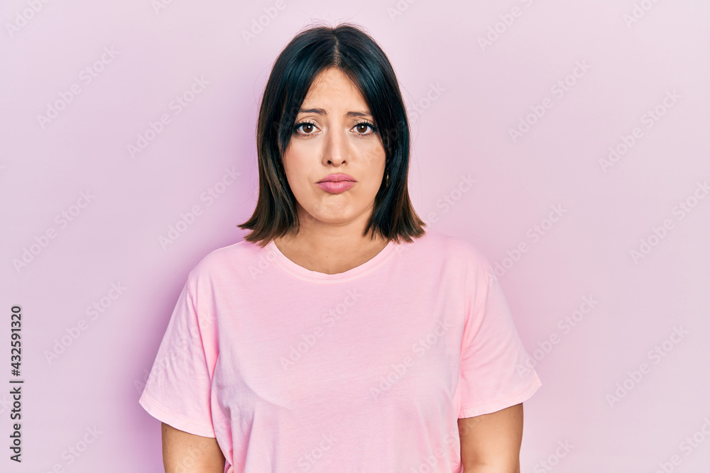 Young hispanic woman wearing casual pink t shirt depressed and worry for distress, crying angry and afraid. sad expression. Young hispanic woman wearing casual pink t shirt depressed and worry for distress, crying angry and afraid. sad expression.