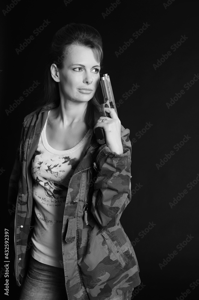 blonde woman in camouflage with arms on a dark background with studio blonde woman in camouflage with arms on a dark background with studio