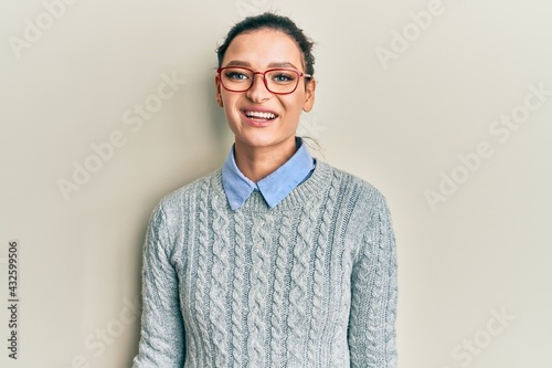 Young caucasian woman wearing casual clothes and glasses with a happy and cool smile on face. lucky person. © Krakenimages.com