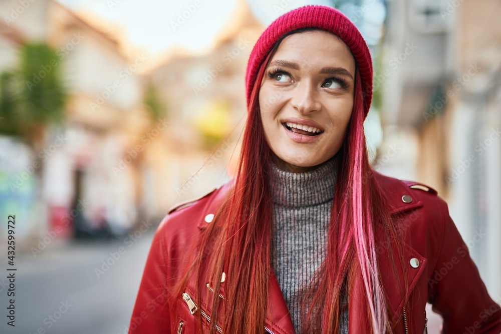 Young caucasian girl smiling happy standing at the city.