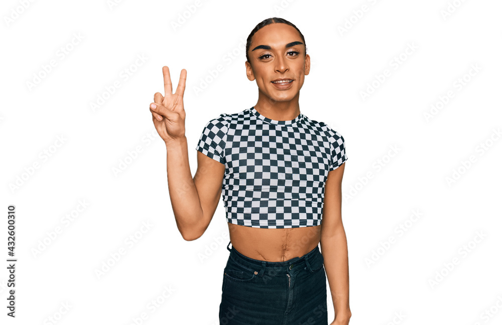 Hispanic transgender man wearing make up and long hair wearing modern clothes showing and pointing up with fingers number two while smiling confident and happy. Hispanic transgender man wearing make up and long hair wearing modern clothes showing and pointing up with fingers number two while smiling confident and happy.