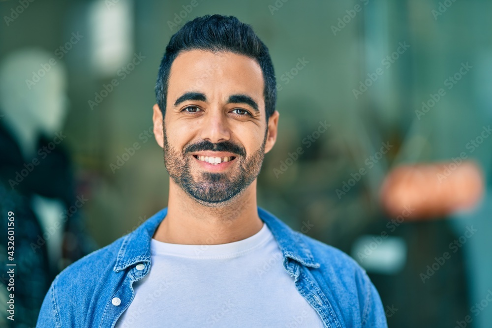 Young hispanic man smiling happy standing at the city. Young hispanic man smiling happy standing at the city.