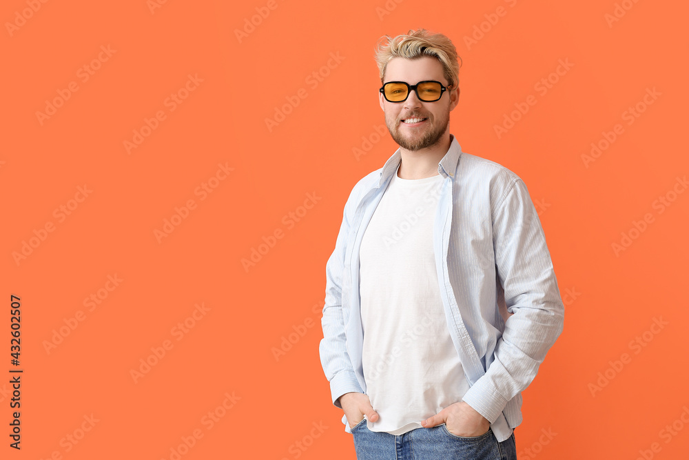 Young man with stylish sunglasses on color background Young man with stylish sunglasses on color background