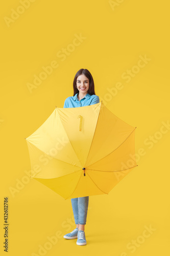 Stylish young woman with um...