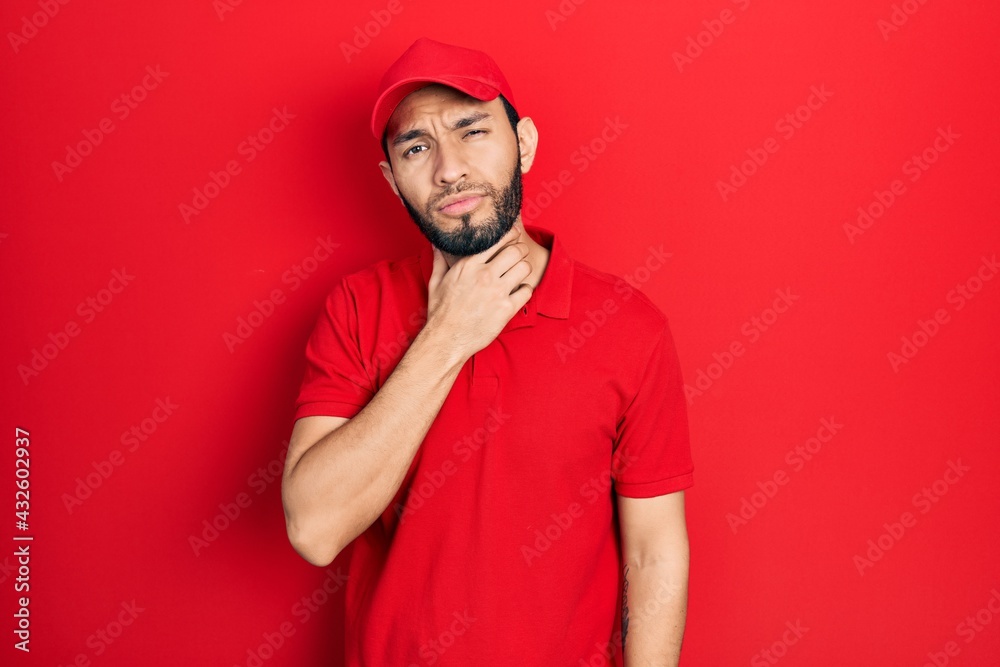 Hispanic man with beard wearing delivery uniform and cap touching painful neck, sore throat for flu, clod and infection