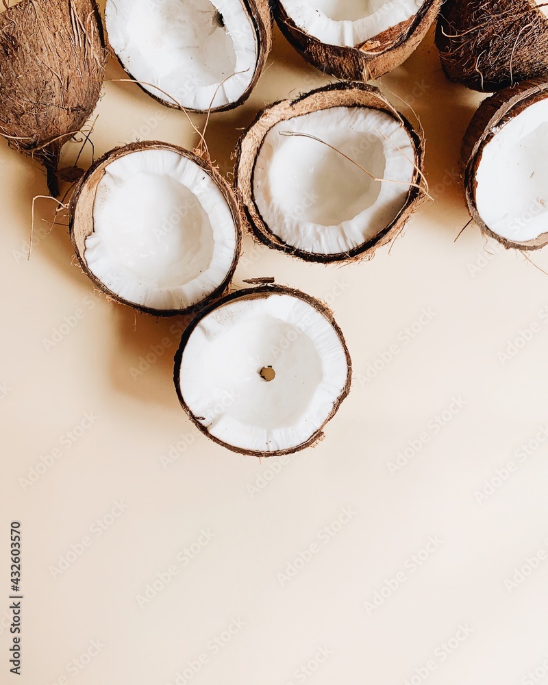 fresh coconut on light gray background. Flat lay, top view, copy space. Summer background, nature. Healthy cooking. Creative healthy food concept, half of coconut fresh coconut on light gray background. Flat lay, top view, copy space. Summer background, nature. Healthy cooking. Creative healthy food concept, half of coconut