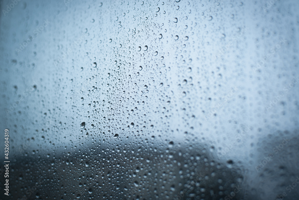Raindrops on a window, rainy weather, cloudy day. Selective focus, blurred edges. Raindrops on a window, rainy weather, cloudy day. Selective focus, blurred edges.