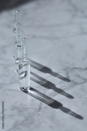 mesotherapy serum. cosmetic ampoules on a marble background.Beauty and skin care concept