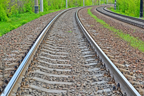 long distance railway transportation, right turn railroad track with green embankment environment, modern tourism diversity