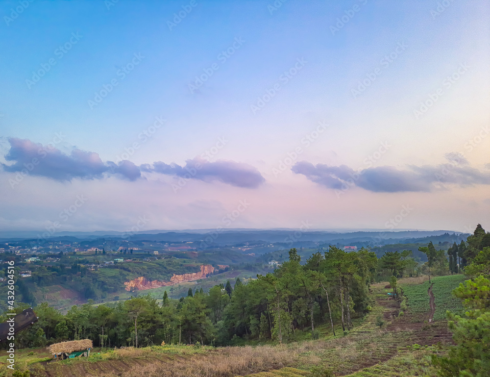 Fototapeta premium sunset dramatic sky with mountains and forests from flat angle at dusk