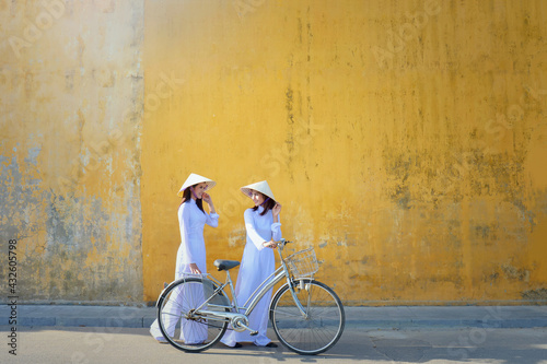 Asian woman Vietnam culture traditional dress on sandune during sunset ,traditional costume ,Muine Vietnam photo