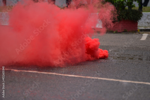 Smoke bombs with red smoke on road
