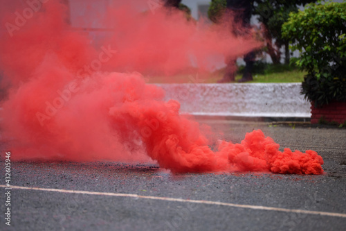 Red bomb smoke on road