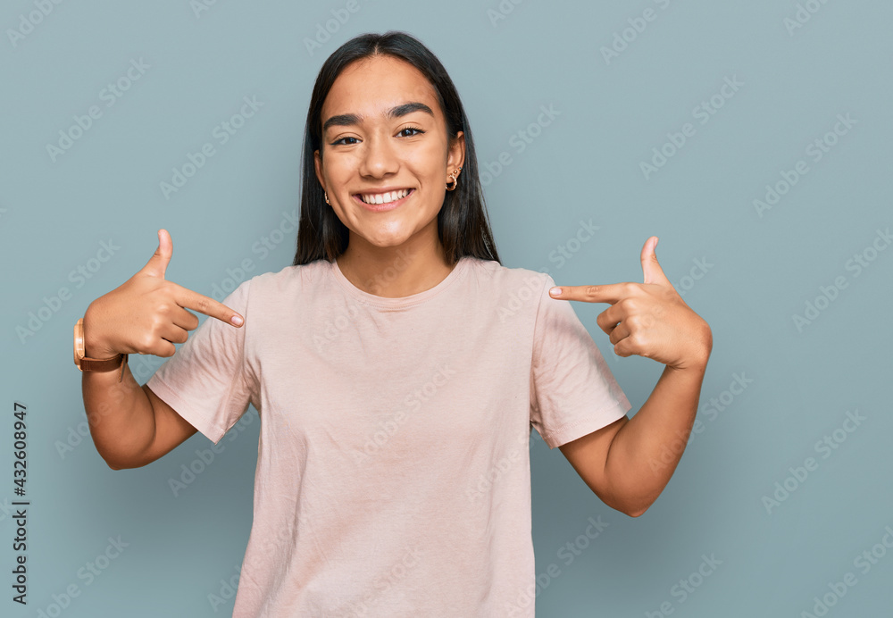 Young asian woman wearing casual clothes looking confident with smile on face, pointing oneself with fingers proud and happy. Young asian woman wearing casual clothes looking confident with smile on face, pointing oneself with fingers proud and happy.