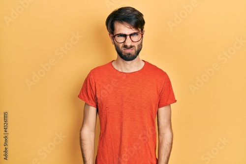 Young hispanic man wearing casual clothes and glasses skeptic and nervous, frowning upset because of problem. negative person.
