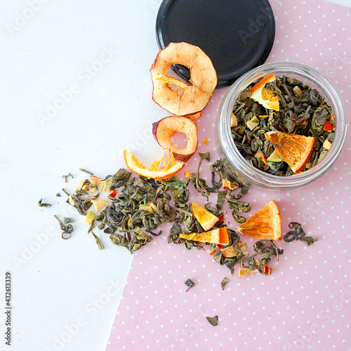 dried fruit in a jar and on the table. vegetarianism and healthy eating. energy for all time from healthy food. beautiful fruits in jars. weight loss. orange white glass. High quality photo
